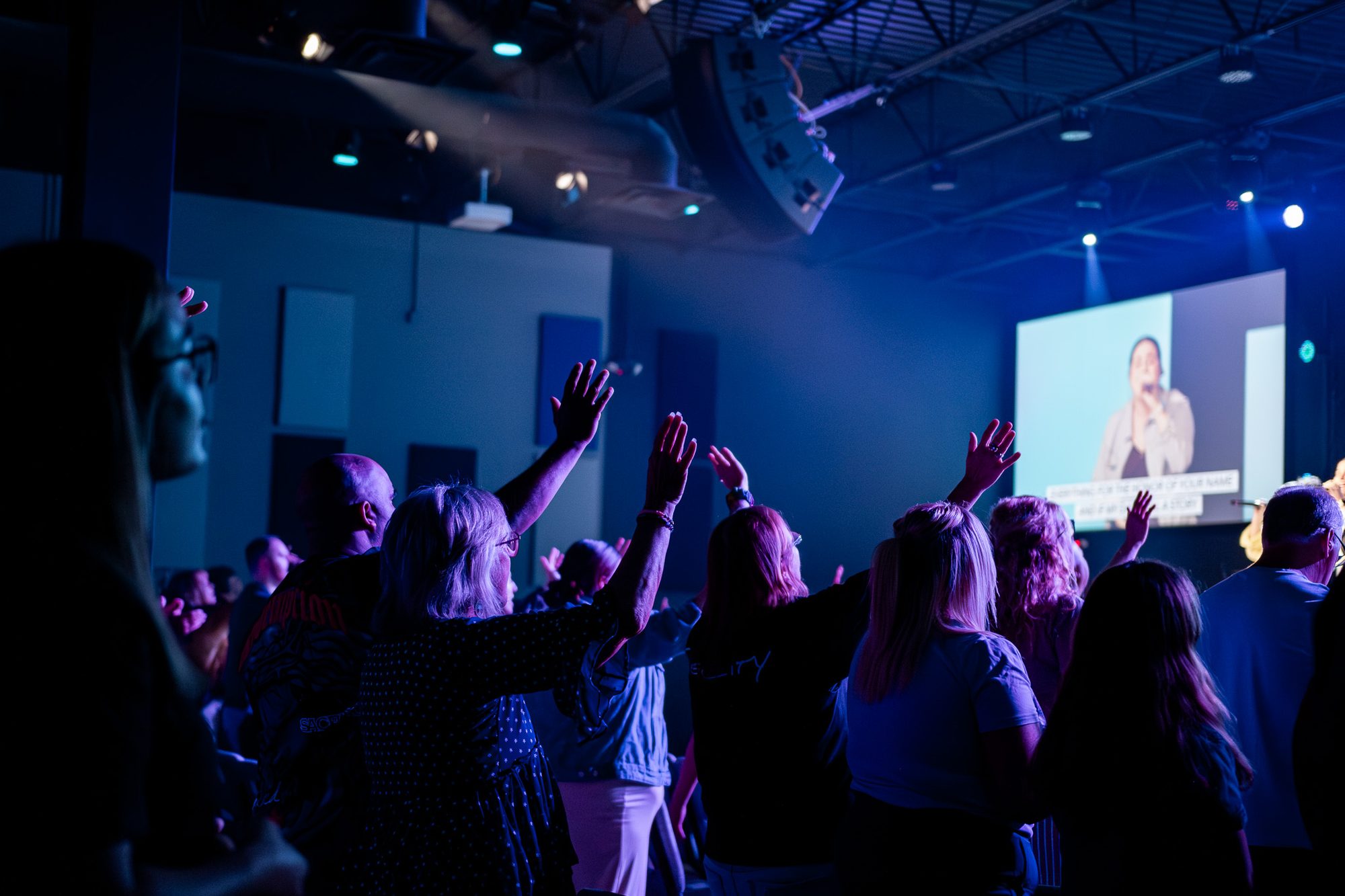 The congregation with hands raised during worship